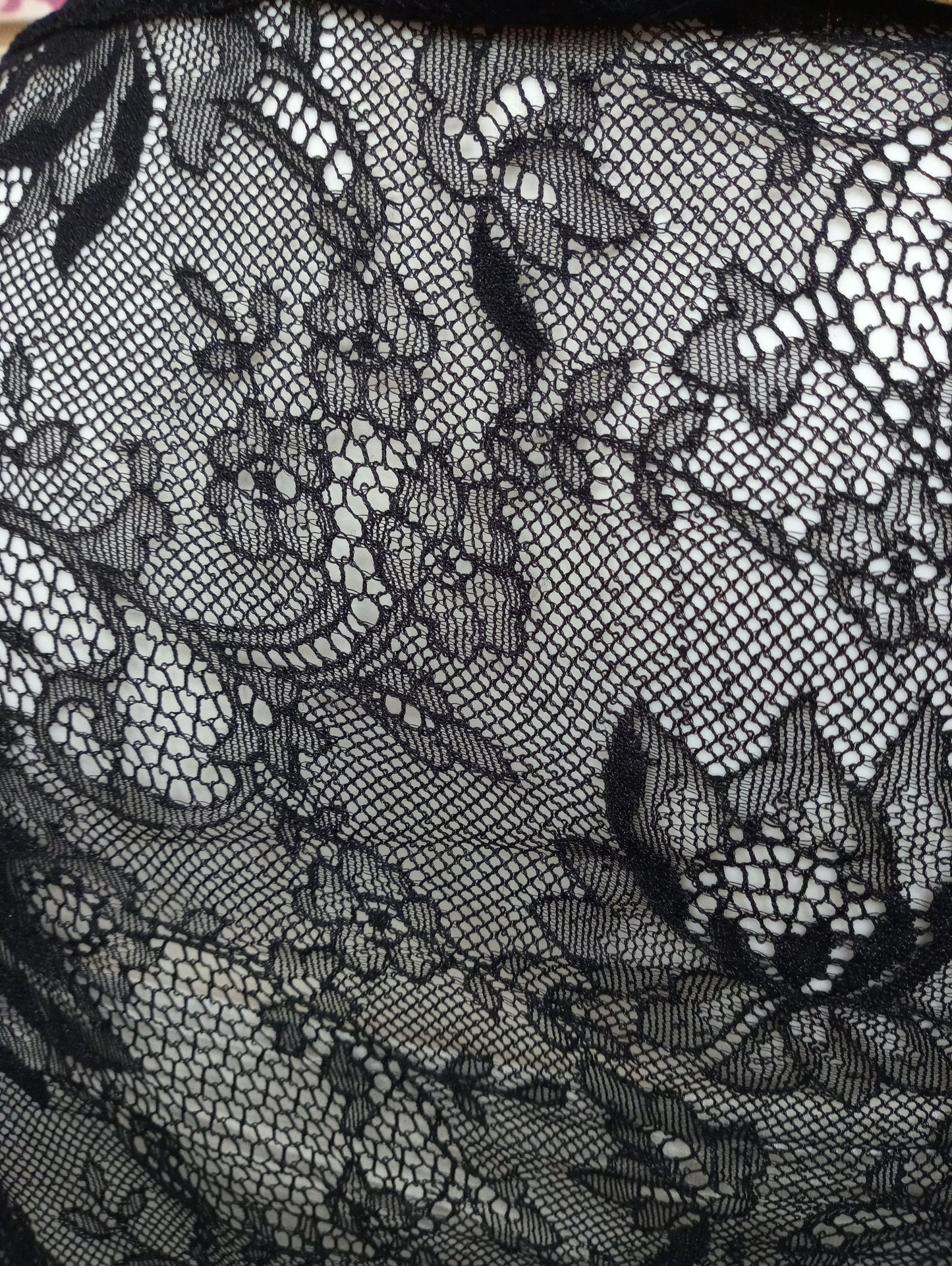 Dettaglio di tessuto in pizzo nero con motivo floreale, streetwear donna elegante