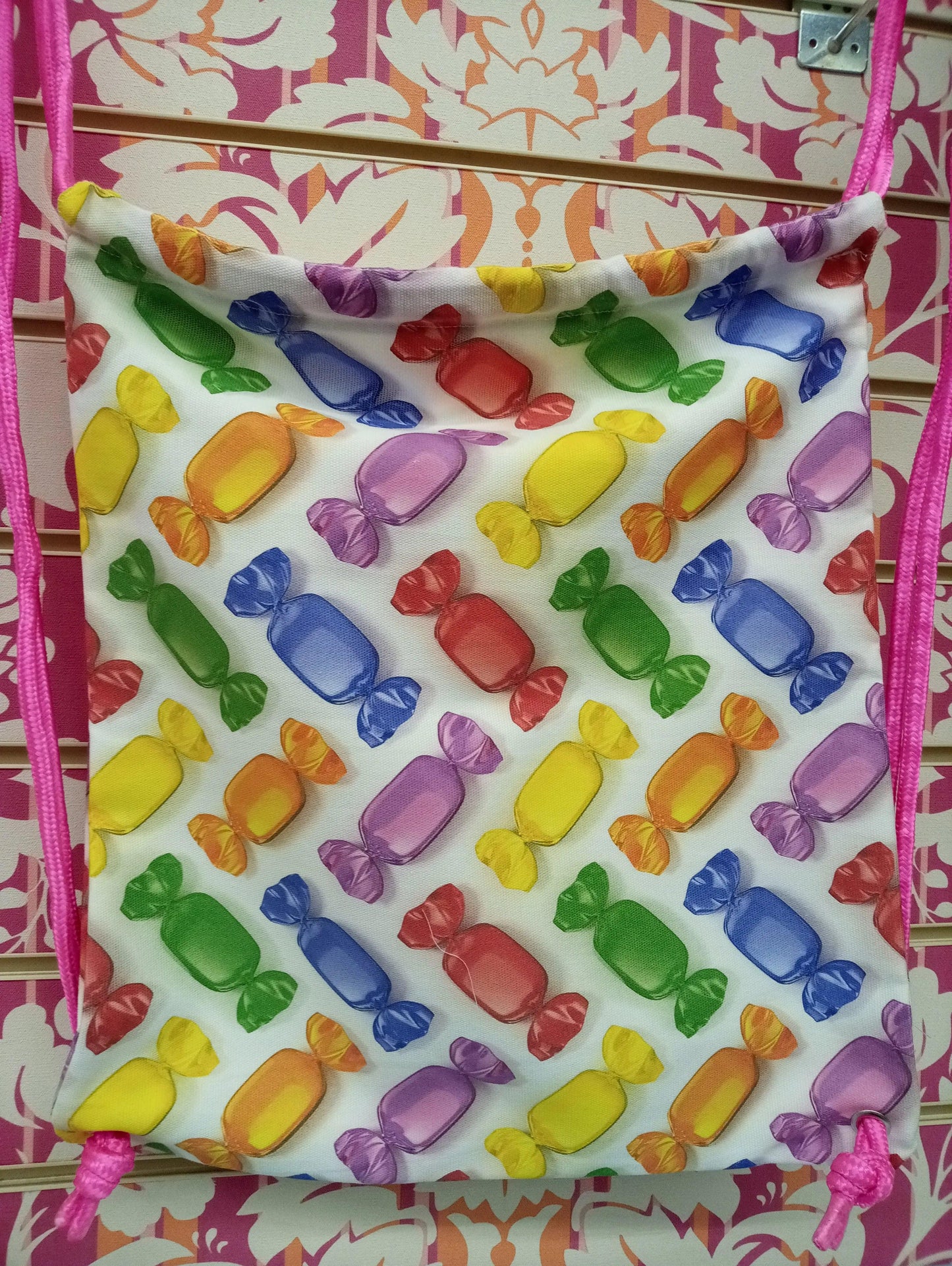 Zaino a sacca streetwear con fantasia caramelle colorate, sfondo rosa decorato